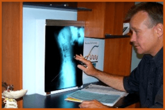 Dr. Lewallen Checking X-Ray Report
